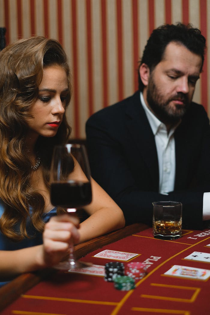 Mastering the First Impression: Your intriguing post title goes here A woman and man gamble at a casino with drinks and poker chips on the table.
