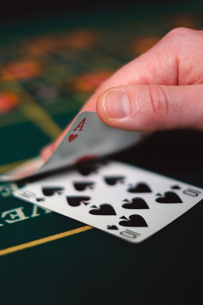 about-01 Tense moment in a casino with a hand revealing a winning card on a table.