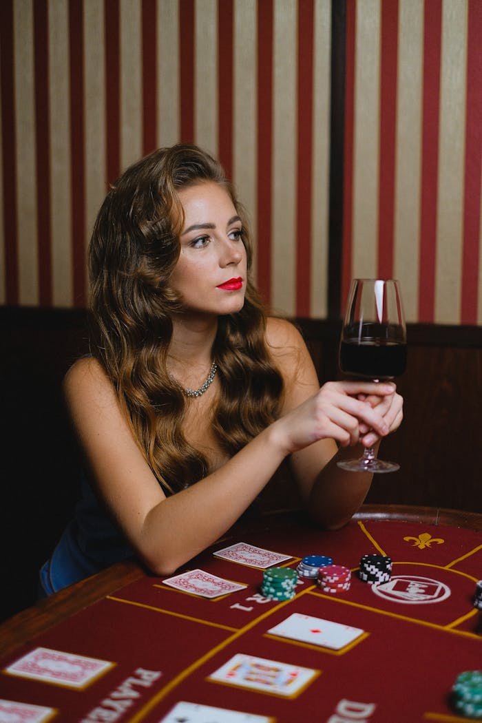 Crafting Captivating Headlines: Your awesome post title goes here Stylish woman with wine glass at poker table, exuding elegance and concentration.